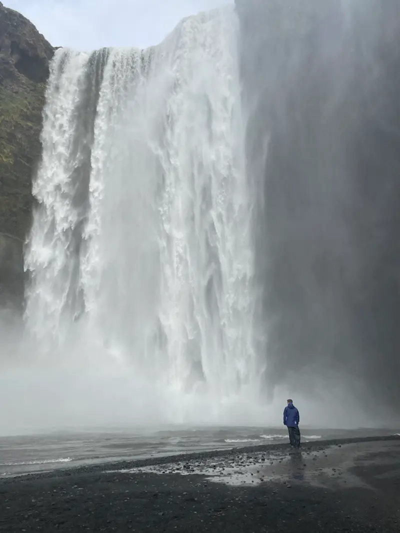 Standing in the mist of mighty falls in Iceland.