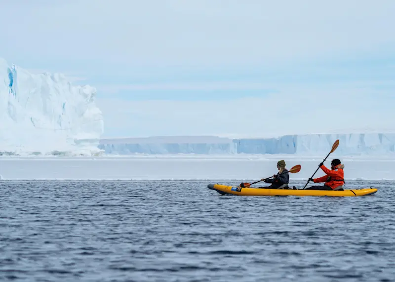 Kayaking with penguins in Antarctica.