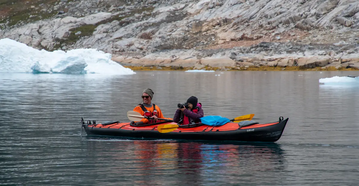Nat Hab guests kayaking, Sermilik Fjord, Greenland.