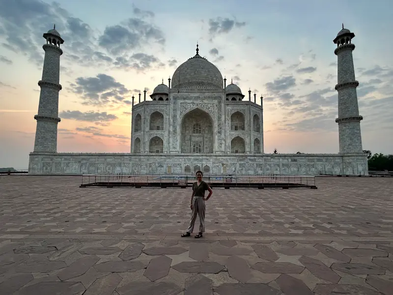 Standing before the ivory-white marble masterpiece at sunrise in Agra, India. 
