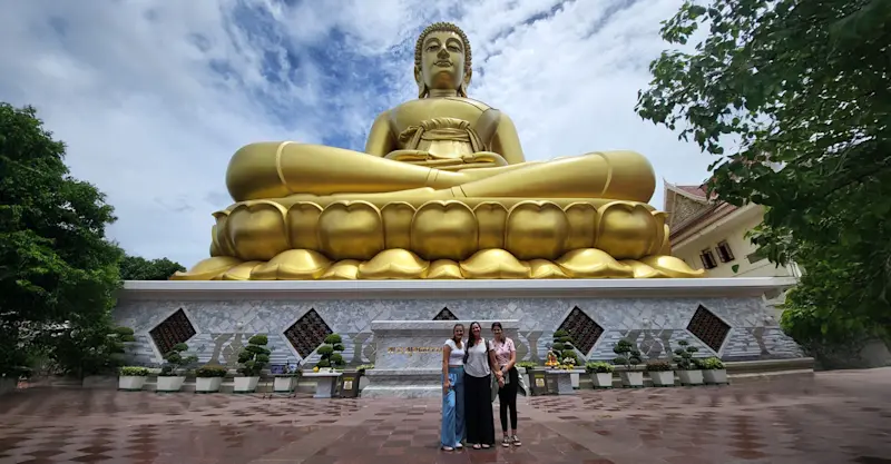 Sharing a heartful moment with my daughters at the Big Buddha in Bangkok, Thailand.