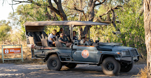 Travelers leaving camp in a safari truck