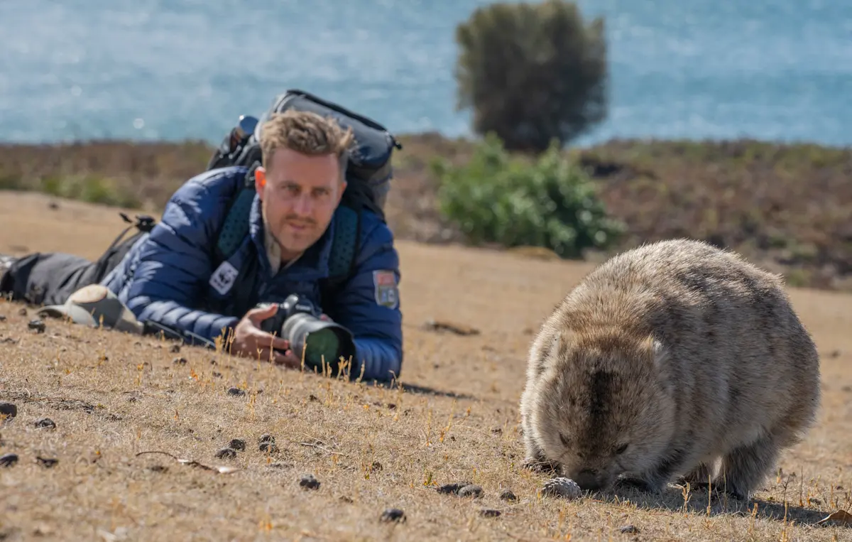 Nat Hab Expedition Leader and wombat, Maria Island, Tasmania.