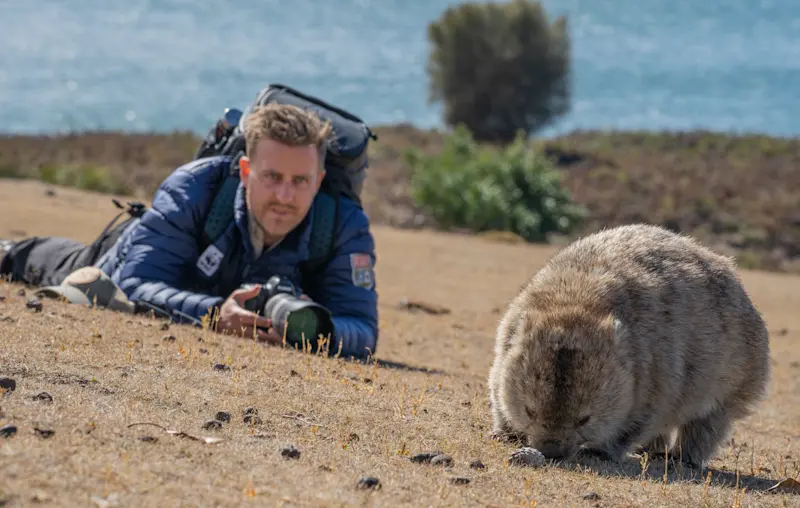 Nat Hab Expedition Leader and wombat, Maria Island, Tasmania.