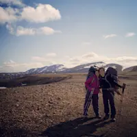 Chasing waterfalls and quiet moments together across dramatic landscapes in Iceland.