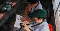 Earthwatch Expeditions guests identify birds, Amazon, Peru.