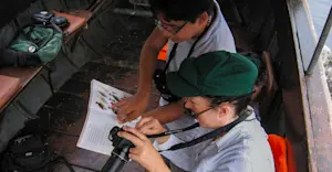 Earthwatch Expeditions guests identify birds, Amazon, Peru.