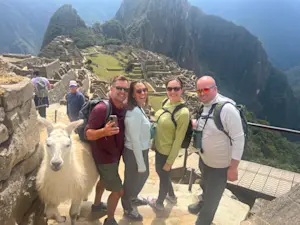 Hiking with friends and enjoying a visit from the llamas and alpacas in Machu Picchu, Peru.