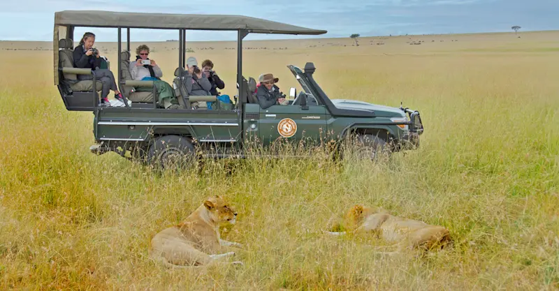 Nat Hab guests and lions, Private Mara Conservancy, Kenya.