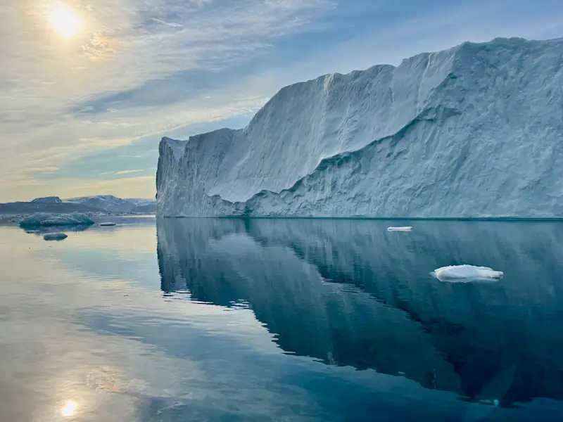 Unreal icebergs, stunning reflections—the magic of our boat ride on icy waters in Greenland.