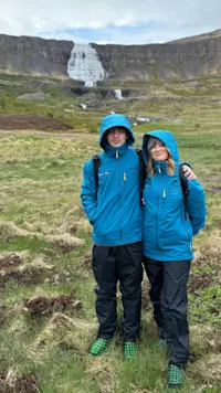 Standing before the cascading Dynjandi Waterfall in Iceland.