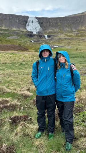 Standing before the cascading Dynjandi Waterfall in Iceland.