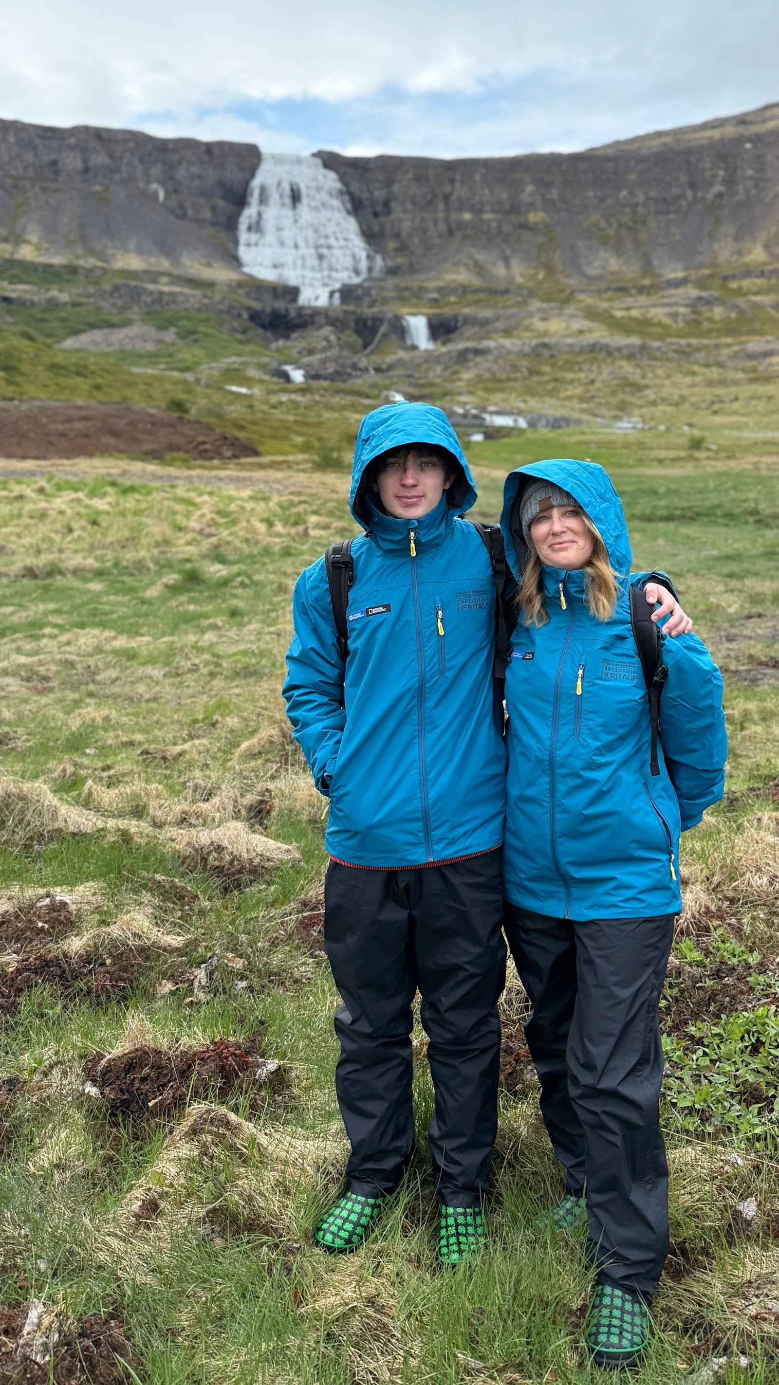 Standing before the cascading Dynjandi Waterfall in Iceland.