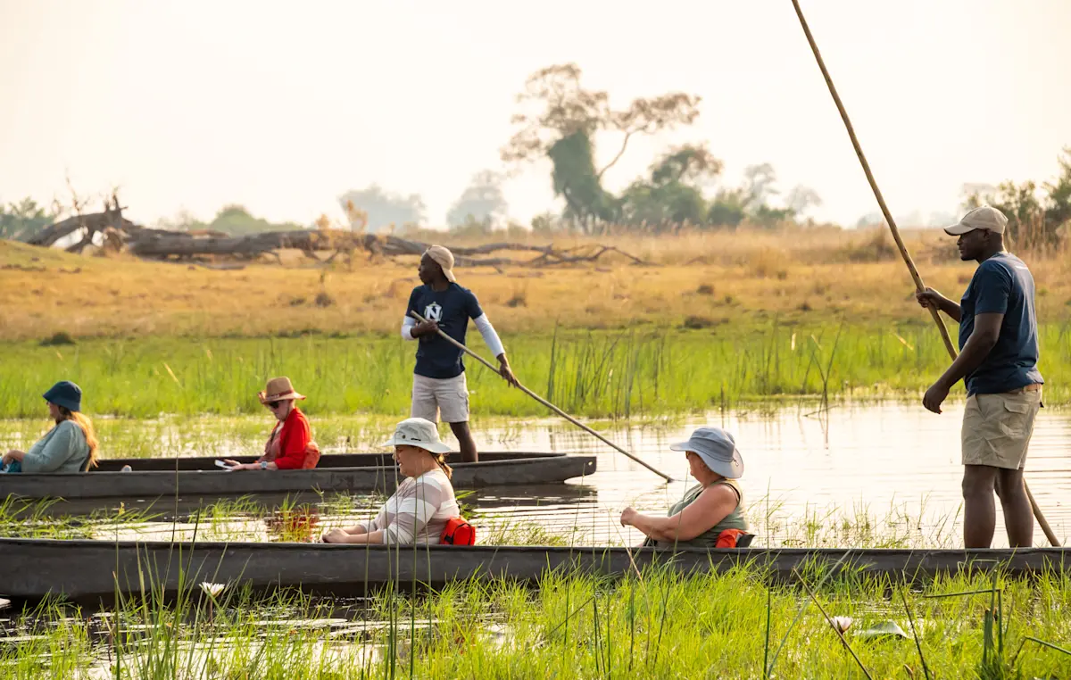 Nat Hab guests and guides on a mokoro safari, Okavango Delta, Botswana.