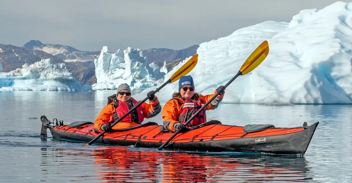 Nat Hab guests kayaking, Sermilik Fjord, Greenland.