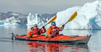 Nat Hab guests kayaking, Sermilik Fjord, Greenland.