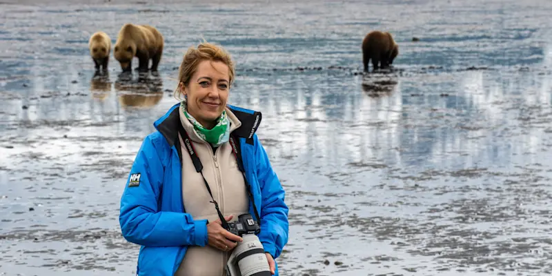 Nat Hab guest with brown bears, Nat Hab's Alaska Bear Camp, Lake Clark National Park, Alaska.