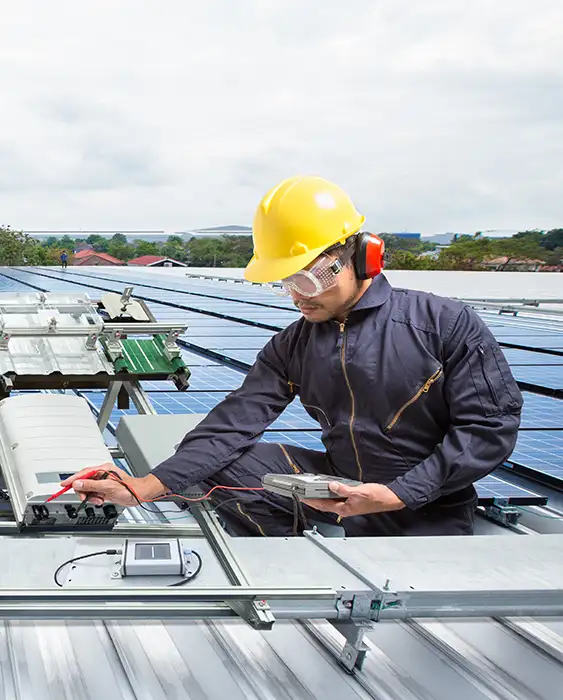 A technician working on the rooftop with solar panels.