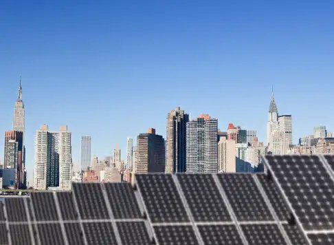 Solar panels in the foreground with the New York City skyline
