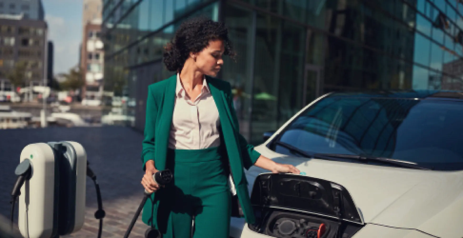 Woman charging a white ev