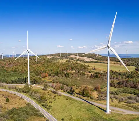 Aerial view of windmills against a blue sky.