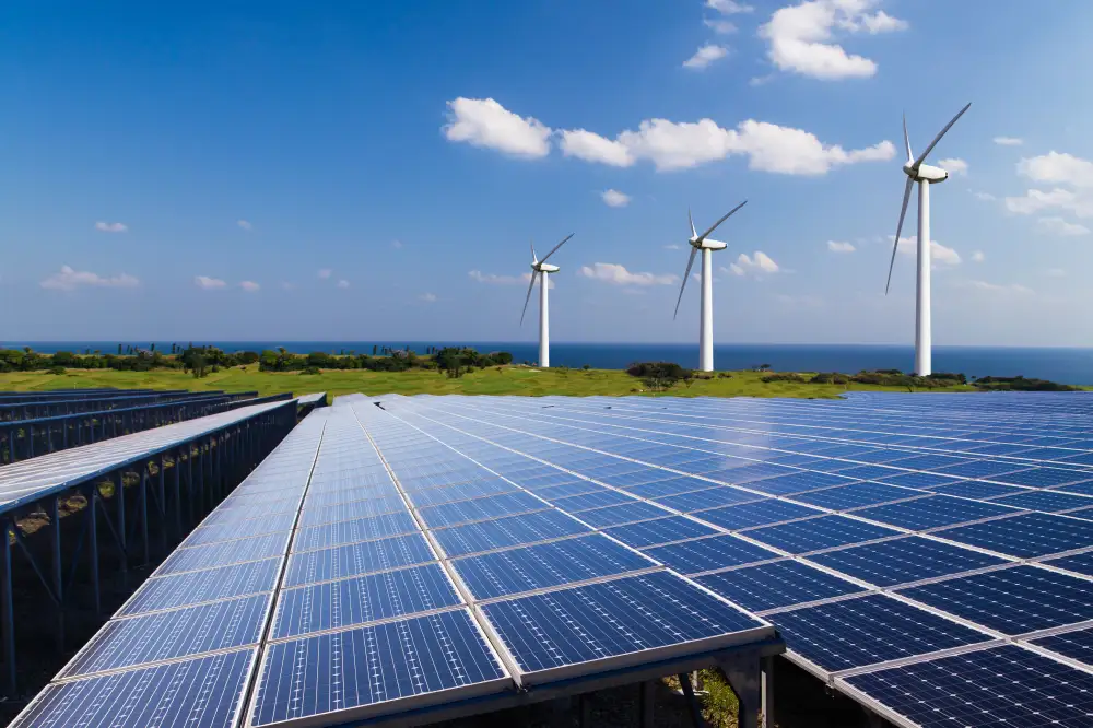 Three windmills and a field of solar panels