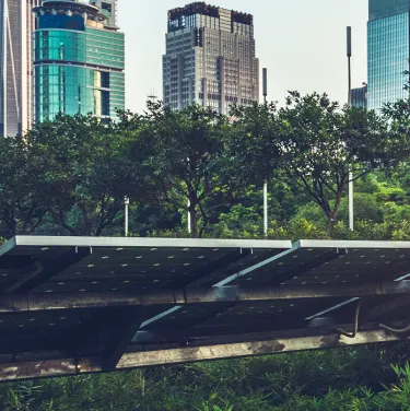 solar panel with city skyline backdrop