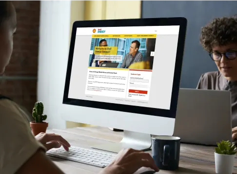 Woman looking at a computer with the Shell wholesale portal