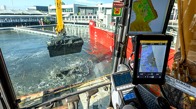 Excavator dredging a marina using Trimble Earthworks machine control for a real-time 3D view of the operation