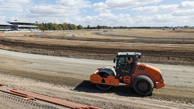 Soil compactor with Trimble Earthworks Grade Control compacting a racecourse