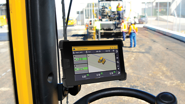 View from inside a paver's cab showing the TD520 display, Trimble Roadworks and real-time paving data