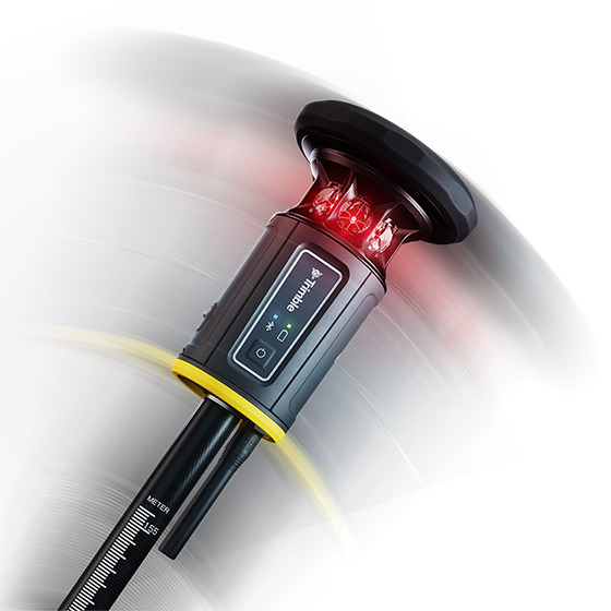 A close-up of a tilted Trimble ST30 smart target mounted on a survey pole and featuring a glowing red LED light.
