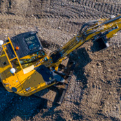 Compact excavator in a field