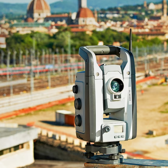 Trimble S9 total station set up with a city scape in the background