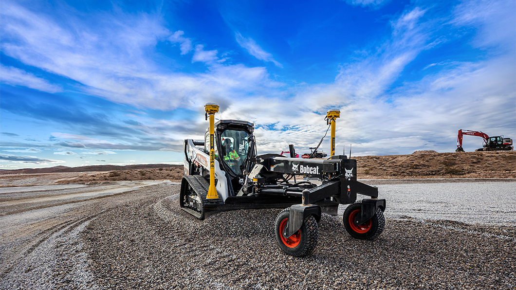 Compact track loader with grader attachment using Trimble Grade Control on construction site