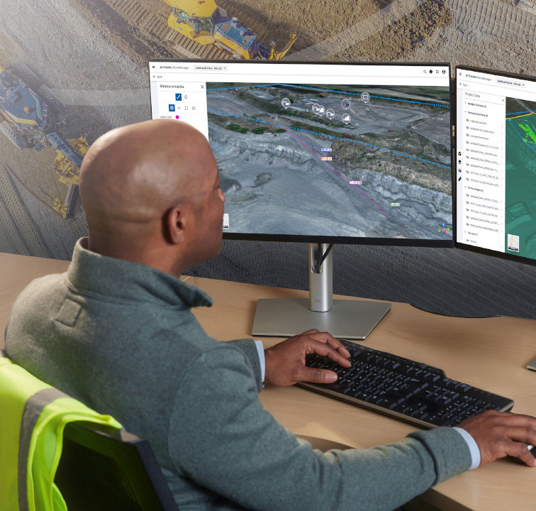 Construction worker on site using Trimble Site Management software for field to office connectivity