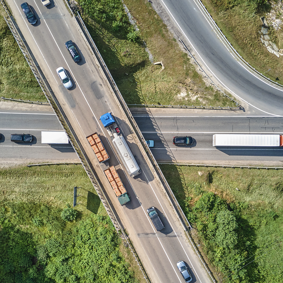 Aerial perspective of a highway filled with cars, illustrating heavy traffic flow