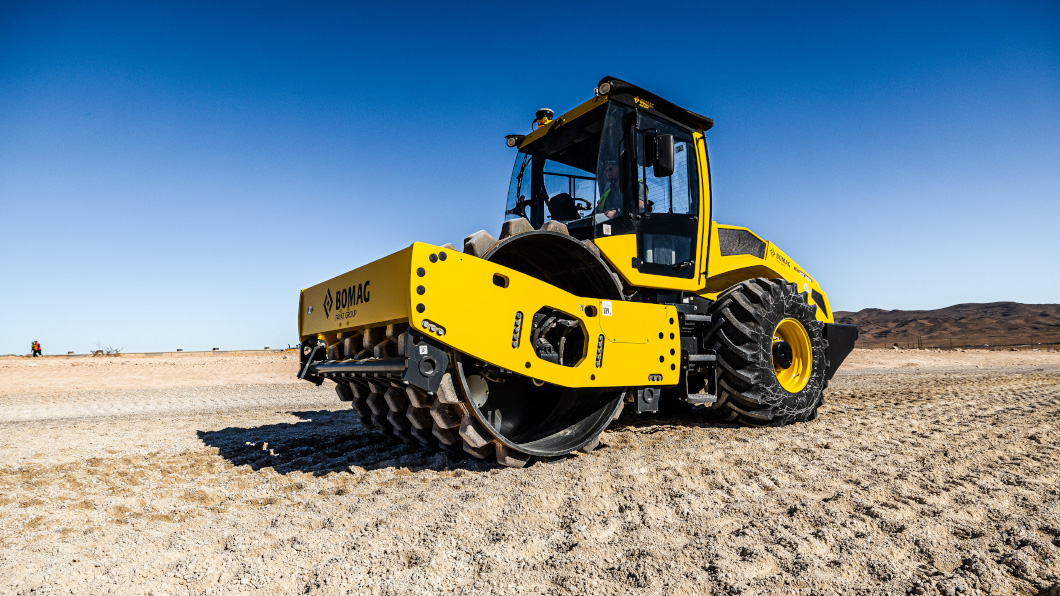 BOMAG soil compactor with Trimble Earthworks grade control works on dirt construction site