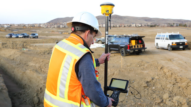 Surveyor with a trimble data collector on a jobsite