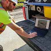 Construction worker on site using Trimble Site Management software for field to office connectivity