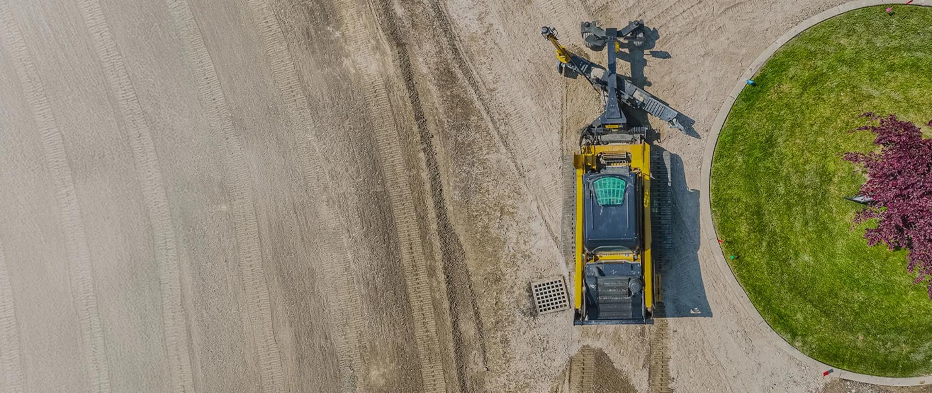 Aerial view of compact grader using Trimble grade control on a residential roading project