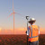 surveying a wind farm at sunrise