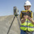 A close-up shot shows a surveyor holding a T110 tablet
