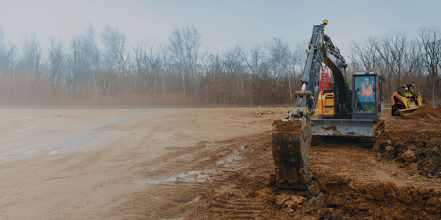 Siteworks Machine Guidance on an excavator and a compact track loader on a dirt construction site
