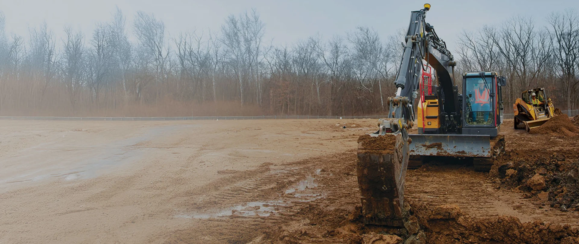 Siteworks Machine Guidance on an excavator and a compact track loader on a dirt construction site
