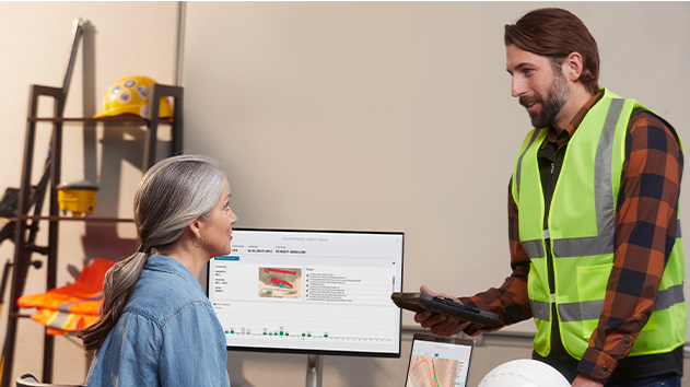 Office collaboration with the computer displaying the latest jobsite information using Trimble WorksManager software