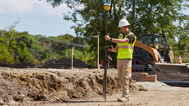 Surveyor using Trimble Siteworks for as-built measurements and grade checks