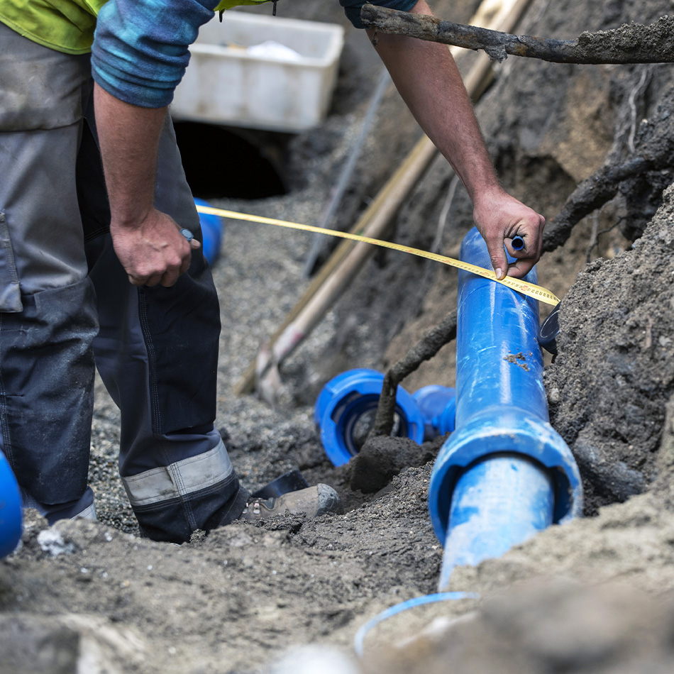 Water pipes being measured in the ground.