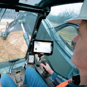 Construction worker in a excavator cab using siteworks
