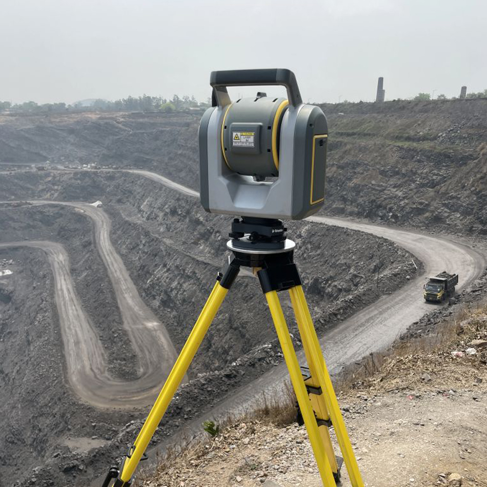 Trimble SX12 scanning total station set up on a tripod near a mining site